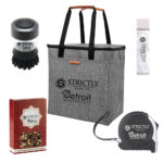 Strictly KB Swag Bundle 2.0: (1) Heather Grey Cooler Tote, (1) Retractable Tape Measure, (1) Soap Dispensing Dish Scrubber, (1) Chocolate Covered Pretzels Gift Box, (1) Margarita Flavored Premium Lip Balm